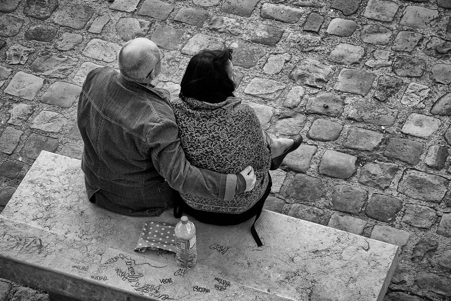 unusual Paris - a couple enjoying a mild spring day overlooking river Seine